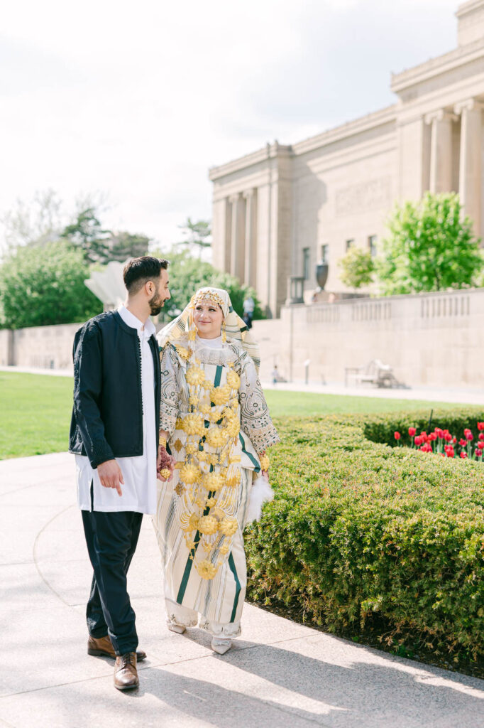 couple in traditional libyan attire walking outside the nelson atkins museum in kansas city