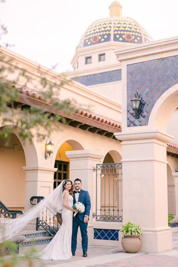 wedding portraits of a couple standing in front of the rio grande city city hall