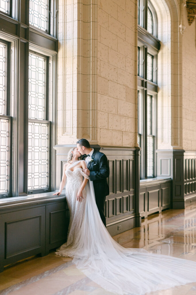 indoor wedding portraits of a couple kissing taken at the century club in kansas city