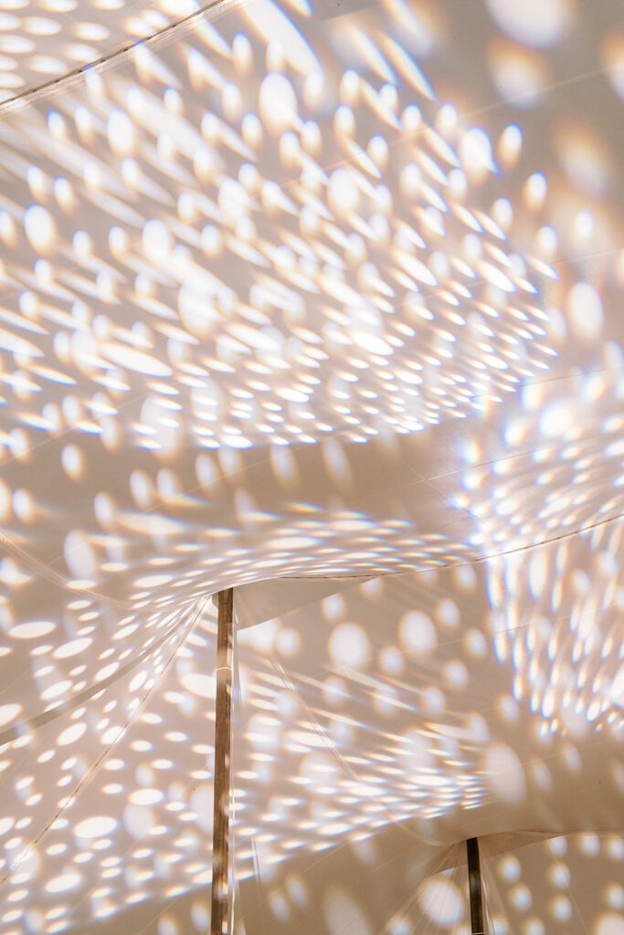 photo of lights shining on the tented reception
